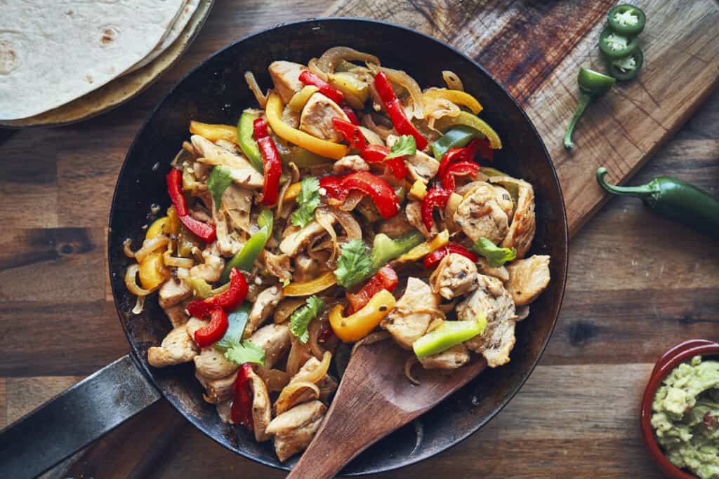 Fajitas de Pollo Chicken marinated Tortillas with Onions and Peppers