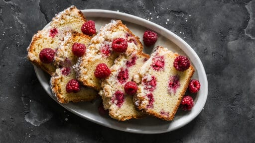 Raspberry cake is a delicious summer dessert on a dark background, top view