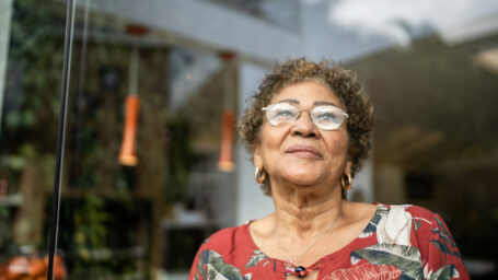 Happy senior woman contemplating at home